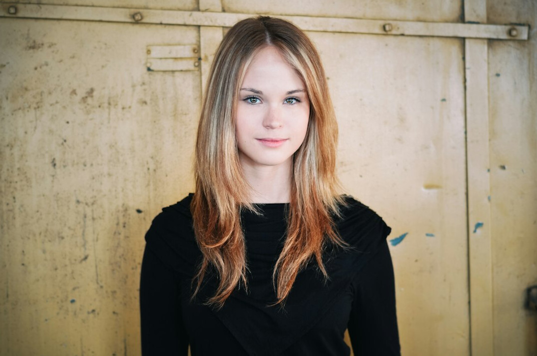 Portrait of a young woman with long hair smiling